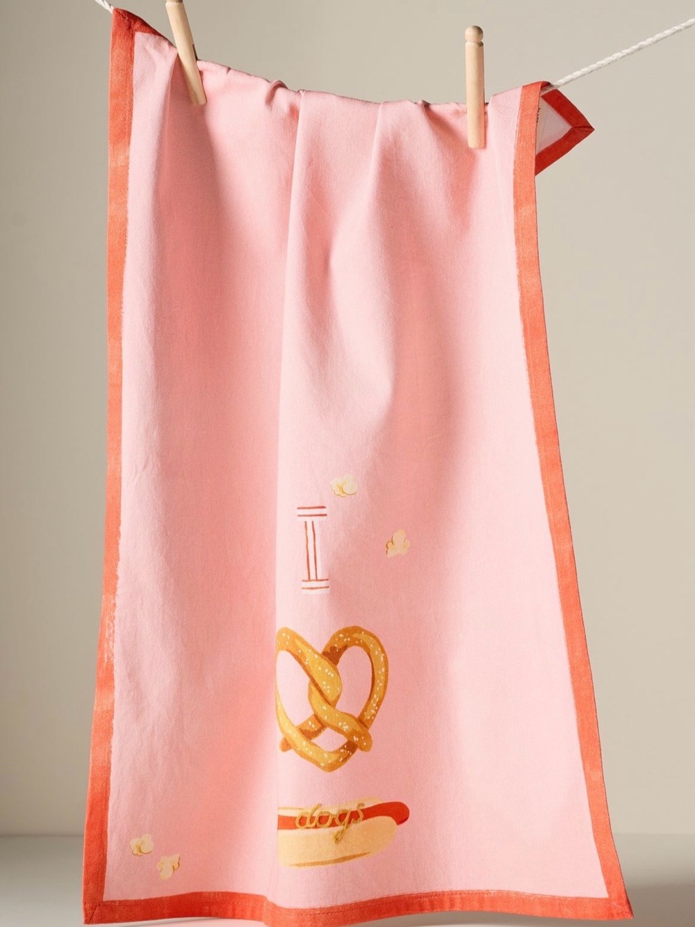 Anthropologie Pink "I love dogs" dish towel with pretzel graphic and hot dog